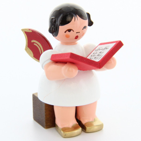 Engel sitzend mit Buch, rote Flügel